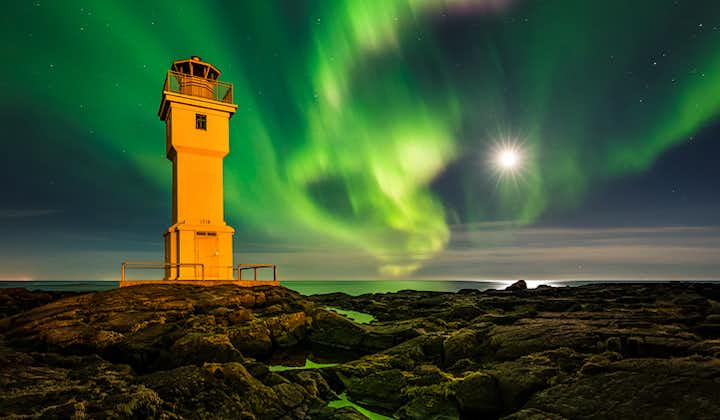 The Aurora Borealis dances above one of Iceland's lighthouses.