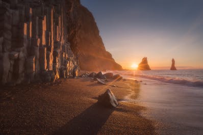 The Reynisdrangar sea stacks in folklore are said to be the petrified remains of greedy trolls  caught in the sunlight and it is possible to view them from the town of Vík as well as Reynisfjara beach.