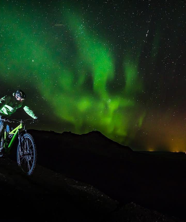 Cycling beneath the Northern Lights Aerial view of Iceland - Photo by Snorri Thor Tryggvason