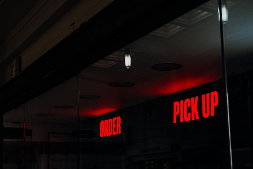 Two neon signs at a take-away restaurant.