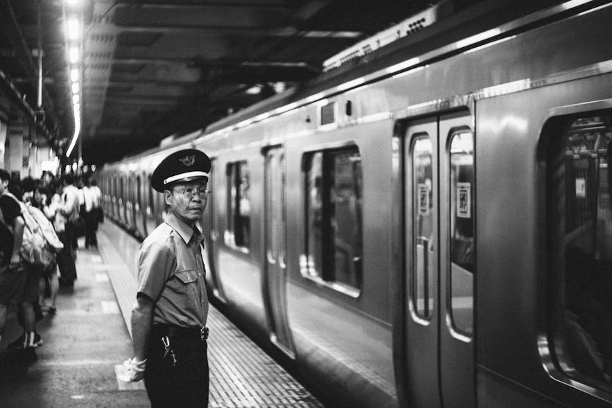 A subway attendant watching an underground train.