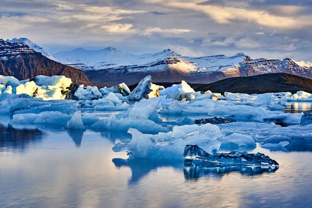 Jokulsarlon Glacier Lagoon showcasies majestic floating icebergs against a backdrop of stunning natural beauty.