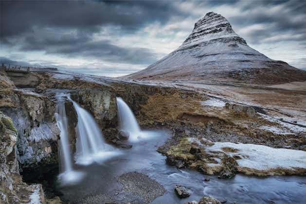 Capture the perfect shot of Kirkjufell Mountain alongside the mesmerizing cascading waterfall, creating a stunning natural spectacle.