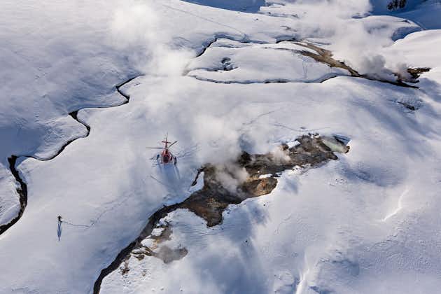 Witness the elegant descent as the helicopter lands softly on the untouched expanse of snow, promising a unique geothermal adventure.