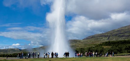 People watch as the awe-inspiring Strokkur geyser explodes high into the air at the Geysir geothermal area.
