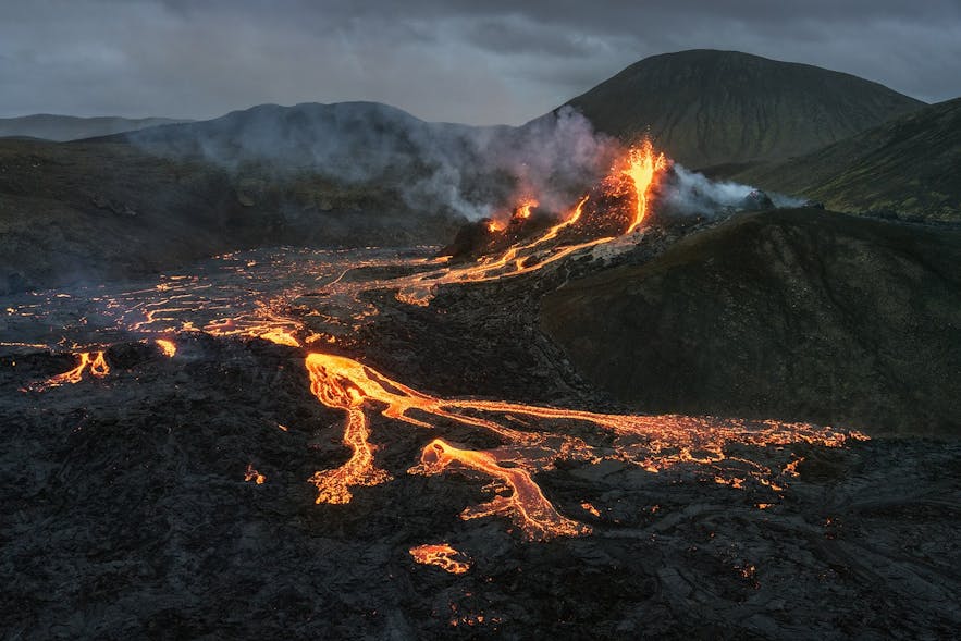 Flames sputter and lava rivers run from the Geldingadalur eruption site in Iceland.