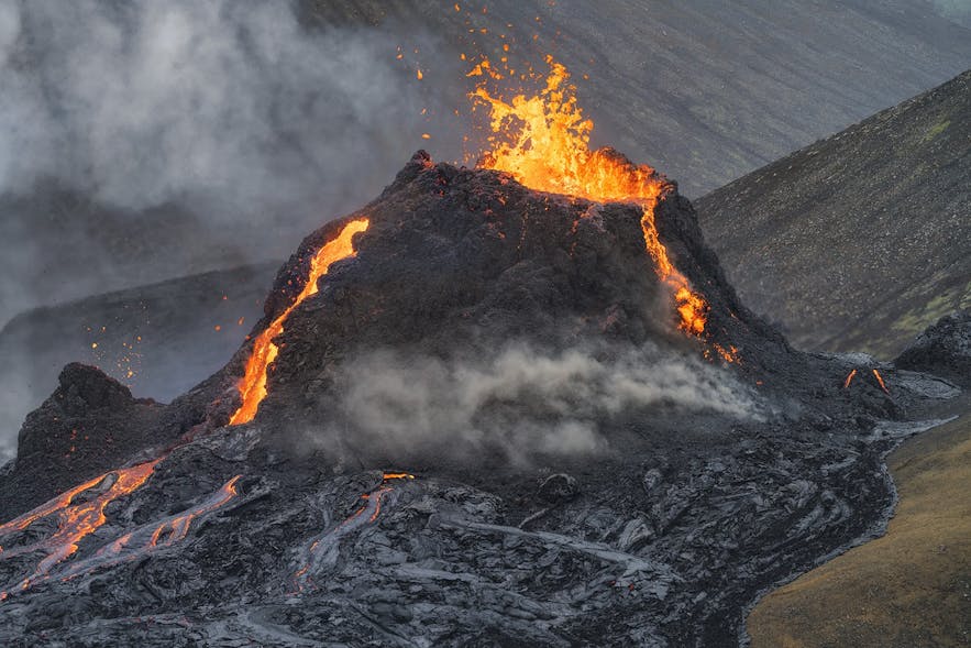 A crater of Geldingadalur volcano froths with fire.