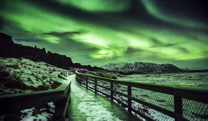 The aurora borealis illuminating a viewing deck in Iceland.