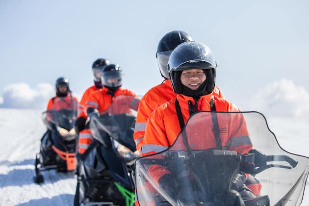 People enjoy a guided snowmobiling tour across the Myrdalsjokull glacier on Iceland's South Coast.