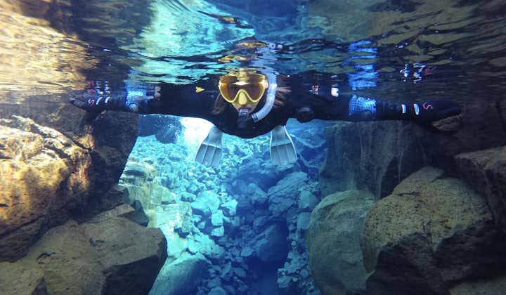 A woman explores the underwater wonders of Silfra during an unforgettable snorkeling adventure.