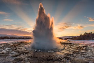Strokkur geyser shoots up superheated waters in the Golden Circle of Iceland.
