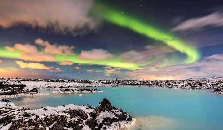 The northern lights shining above the Blue Lagoon during the Icelandic winter.