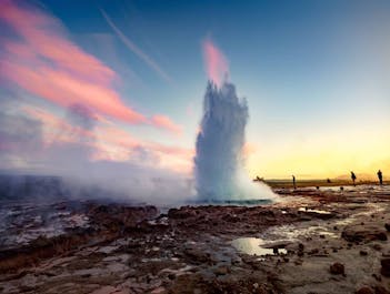 Strokkur Geysir: Nature's explosive masterpiece, showcasing a powerful eruption against Iceland's stunning landscape.