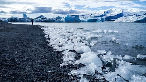 Diamond Beach: Glistening like scattered gems, icebergs from the Jokulsarlon Glacier Lagoon grace the black sands of Iceland's ethereal shoreline.