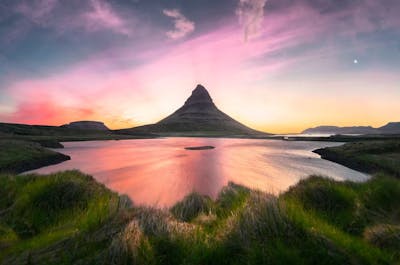 Kirkjufell Mountain's Serene Beauty: The iconic cone-shaped peak stands tall in tranquil majesty, surrounded by the natural wonders of Snaefellsnes Peninsula.