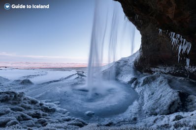 Seljalandsfoss waterfall looks like something from a fairytale, whether you visit in summer or winter.