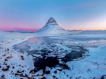 Majestic Kirkjufell mountain adorned in a blanket of winter's pristine beauty.